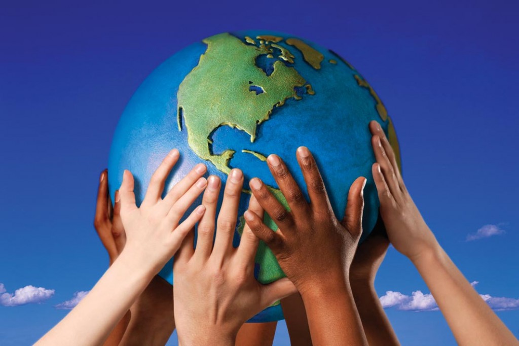 Hands on a globe --- Image by © Royalty-Free/Corbis